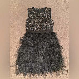 Beautiful Bebe dress with feathers too is stretchy with beading